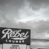 a black and white photo of a sign for the rebel lounge