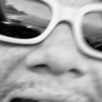 a black and white photo of a person wearing sunglasses